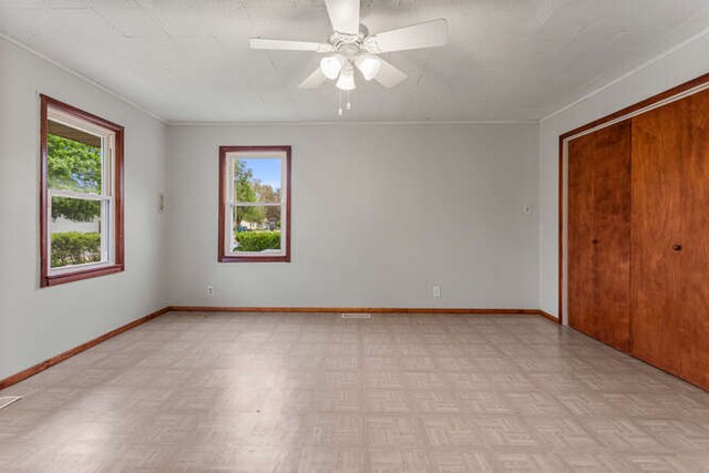 307 N Carico St, Tuscola, IL 61953 - unfurnished room with a ceiling fan, baseboards, and ornamental molding