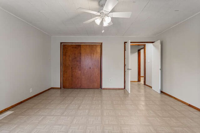 307 N Carico St, Tuscola, IL 61953 - unfurnished bedroom featuring baseboards, a ceiling fan, crown molding, and a closet
