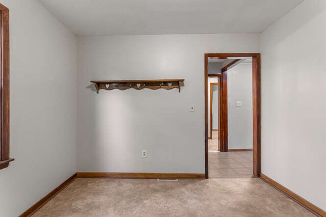 307 N Carico St, Tuscola, IL 61953 - empty room with baseboards and light colored carpet