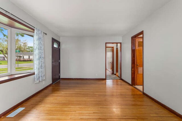 307 N Carico St, Tuscola, IL 61953 - unfurnished room featuring baseboards and light wood-type flooring