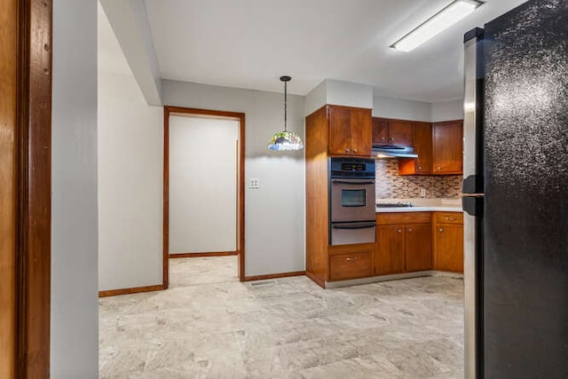 307 N Carico St, Tuscola, IL 61953 - kitchen with appliances with stainless steel finishes, a warming drawer, light countertops, backsplash, and brown cabinetry