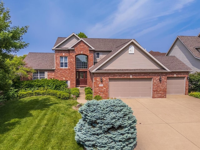 2004 Withers Ln, Bloomington, IL 61704 - view of front of home featuring an attached garage, a front lawn, brick siding, driveway, and roof with shingles