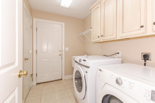 2004 Withers Ln, Bloomington, IL 61704 - laundry area featuring cabinet space, washing machine and clothes dryer, and light tile patterned floors