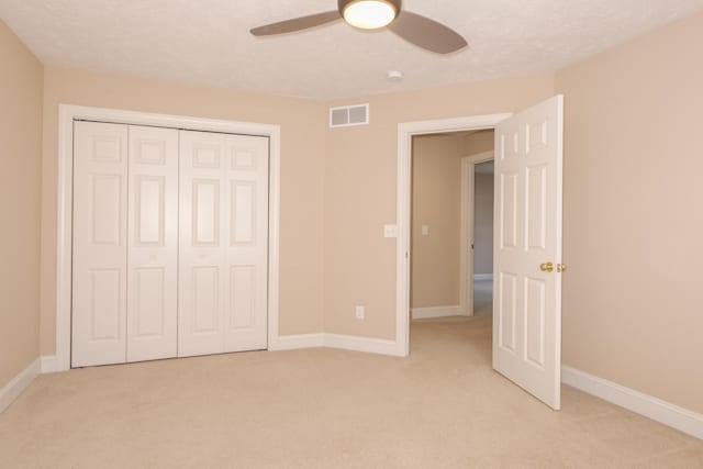 2004 Withers Ln, Bloomington, IL 61704 - unfurnished bedroom with light colored carpet, a closet, and ceiling fan
