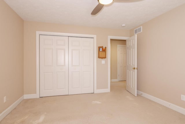 2004 Withers Ln, Bloomington, IL 61704 - unfurnished bedroom featuring light colored carpet, a closet, and a ceiling fan