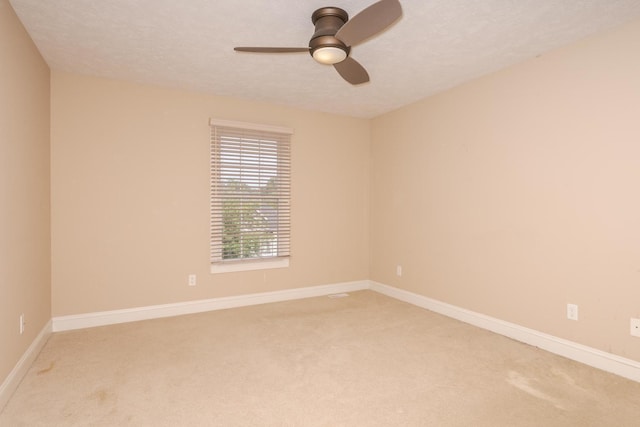 2004 Withers Ln, Bloomington, IL 61704 - empty room featuring light carpet, ceiling fan, and a textured ceiling