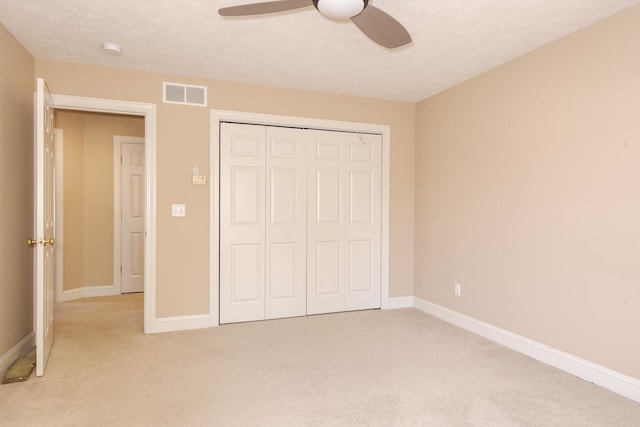 2004 Withers Ln, Bloomington, IL 61704 - unfurnished bedroom with light carpet, a closet, and ceiling fan
