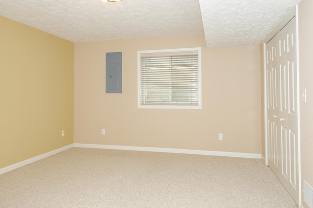 2004 Withers Ln, Bloomington, IL 61704 - empty room with a textured ceiling, electric panel, and carpet
