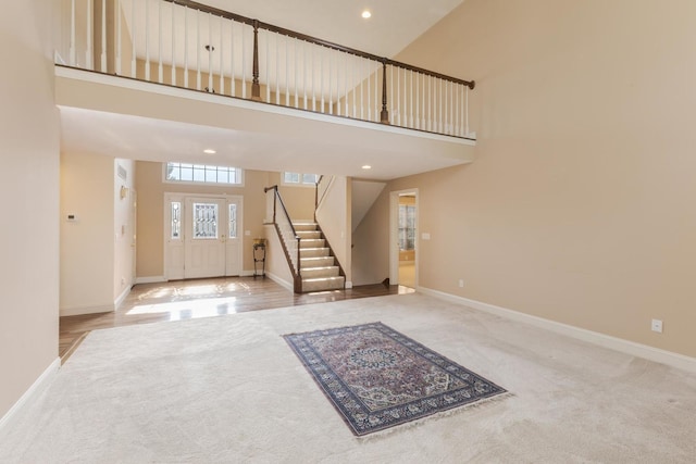 2004 Withers Ln, Bloomington, IL 61704 - foyer featuring carpet floors, a high ceiling, stairs, and recessed lighting