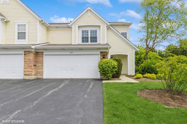 367 S Crown Ct, Palatine, IL 60074 - view of front of house featuring an attached garage, driveway, stone siding, and a front yard