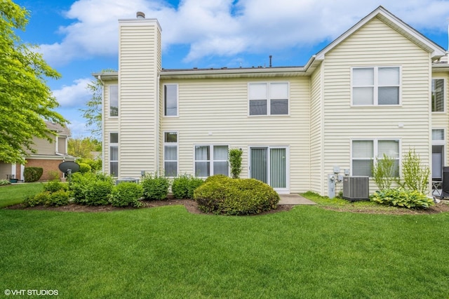 367 S Crown Ct, Palatine, IL 60074 - rear view of house with a chimney, a lawn, and central AC unit