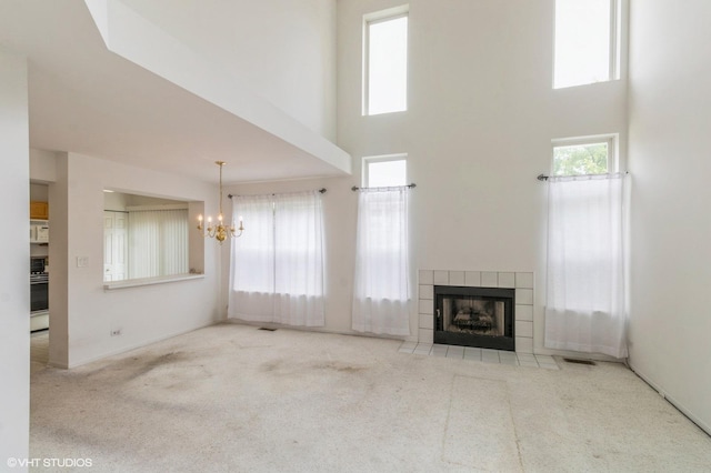 367 S Crown Ct, Palatine, IL 60074 - unfurnished living room featuring a chandelier, a towering ceiling, carpet, and a tile fireplace