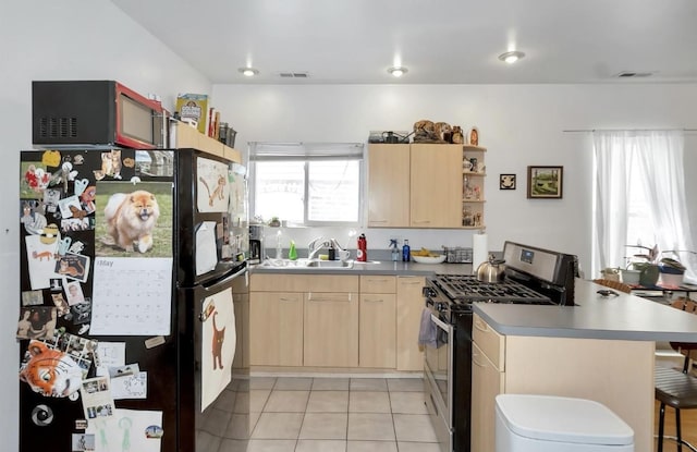 1735 S Desplaines St, Chicago, IL 60616 - kitchen with gas stove, freestanding refrigerator, light brown cabinetry, a peninsula, and a sink