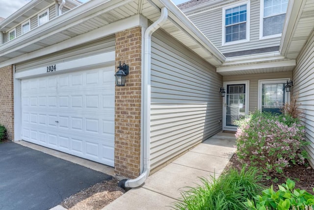 1924 Golden Gate Ln, Naperville, IL 60563 - view of exterior entry with brick siding and asphalt driveway