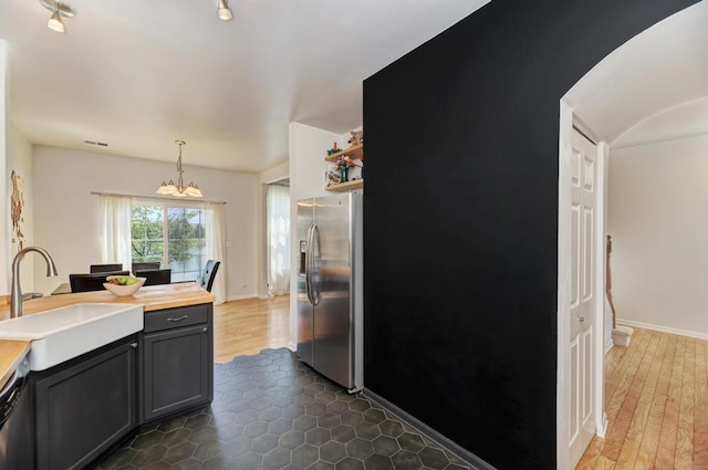 1924 Golden Gate Ln, Naperville, IL 60563 - kitchen featuring stainless steel fridge with ice dispenser, a sink, a chandelier, butcher block countertops, and decorative light fixtures