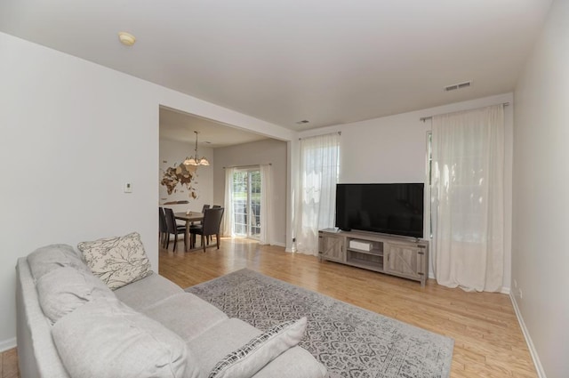 1924 Golden Gate Ln, Naperville, IL 60563 - living room with wood finished floors, a chandelier, and baseboards