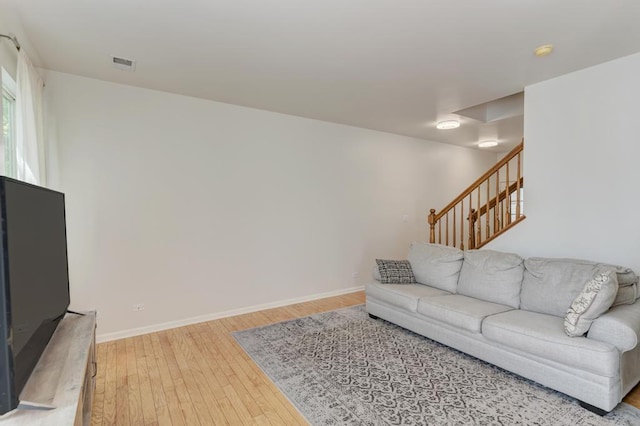 1924 Golden Gate Ln, Naperville, IL 60563 - living area featuring light wood finished floors, baseboards, and stairway