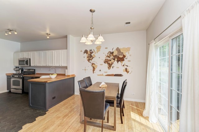 1924 Golden Gate Ln, Naperville, IL 60563 - dining room with a chandelier, light wood-type flooring, and baseboards