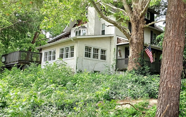 809 S Lynn St, Champaign, IL 61820 - view of property exterior with stucco siding and a wooden deck