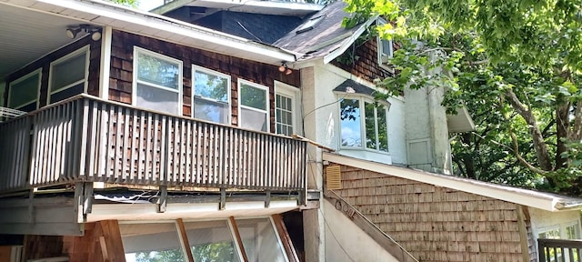 809 S Lynn St, Champaign, IL 61820 - view of property exterior with a shingled roof and a balcony