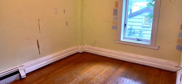 809 S Lynn St, Champaign, IL 61820 - unfurnished room with dark wood-style floors and a baseboard radiator