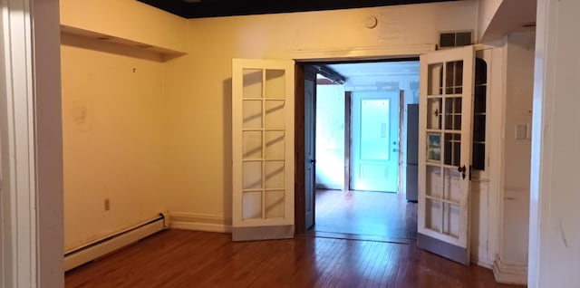 809 S Lynn St, Champaign, IL 61820 - spare room with a baseboard radiator, wood finished floors, and french doors