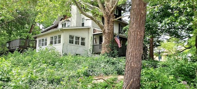 809 S Lynn St, Champaign, IL 61820 - view of side of property featuring stucco siding and a wooden deck