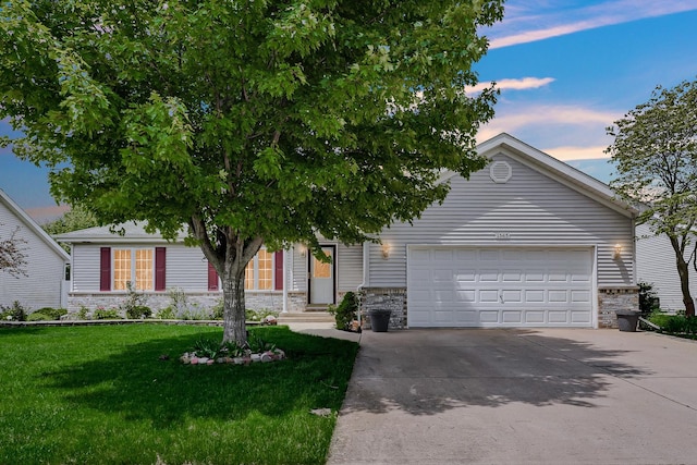 1565 Stefanie Ln, Bourbonnais, IL 60914 - view of front of home featuring stone siding, an attached garage, driveway, and a front yard