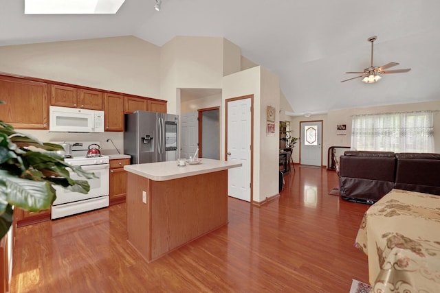 1565 Stefanie Ln, Bourbonnais, IL 60914 - kitchen featuring white appliances, high vaulted ceiling, light countertops, a kitchen island, and wood finished floors