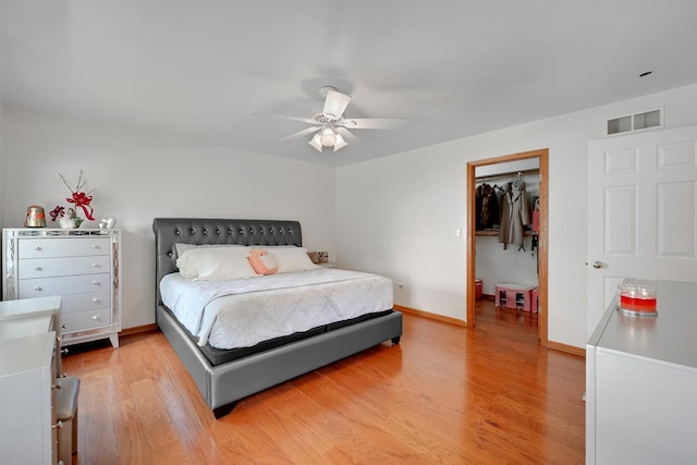 1565 Stefanie Ln, Bourbonnais, IL 60914 - bedroom with light wood-style flooring, baseboards, a spacious closet, and a ceiling fan