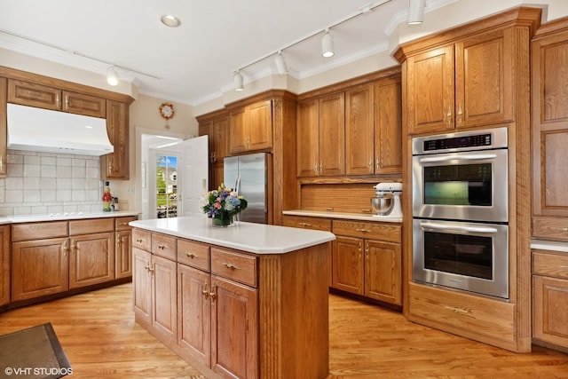 289 S S Shore Ln, Lake Forest, IL 60045 - kitchen with stainless steel appliances, track lighting, range hood, and brown cabinets