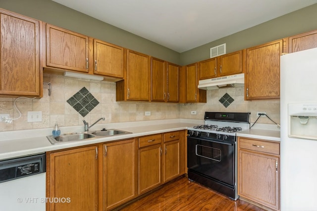 1418 W Split Oak Cir Unit 1418, Round Lake Beach, IL 60073 - kitchen with under cabinet range hood, white appliances, a sink, light countertops, and decorative backsplash