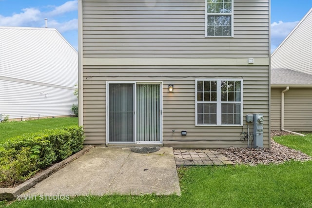 1418 W Split Oak Cir Unit 1418, Round Lake Beach, IL 60073 - back of property with a patio area and a lawn