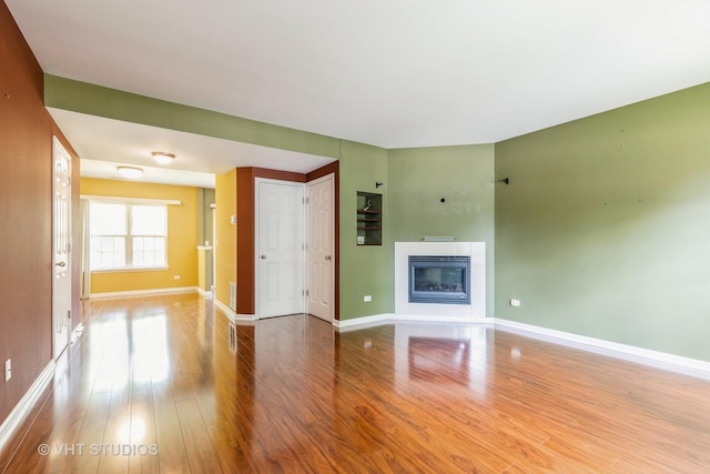 1418 W Split Oak Cir Unit 1418, Round Lake Beach, IL 60073 - unfurnished living room featuring wood finished floors, baseboards, and a fireplace