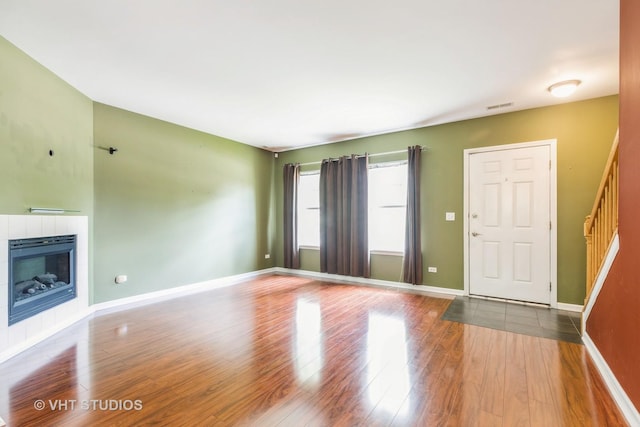 1418 W Split Oak Cir Unit 1418, Round Lake Beach, IL 60073 - unfurnished living room with wood finished floors, baseboards, and a fireplace