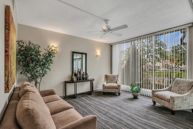 8801 W Golf Rd Unit 10C, Niles, IL 60714 - carpeted living room with a ceiling fan, a wall of windows, a textured ceiling, and baseboards