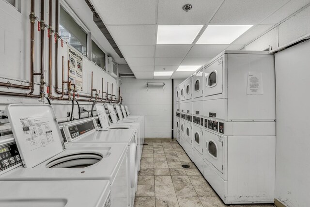 8801 W Golf Rd Unit 10C, Niles, IL 60714 - community laundry featuring washing machine and dryer, concrete block wall, and stacked washing machine and dryer