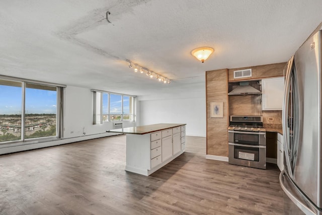 8801 W Golf Rd Unit 10C, Niles, IL 60714 - kitchen with appliances with stainless steel finishes, ventilation hood, white cabinets, dark wood finished floors, and open floor plan