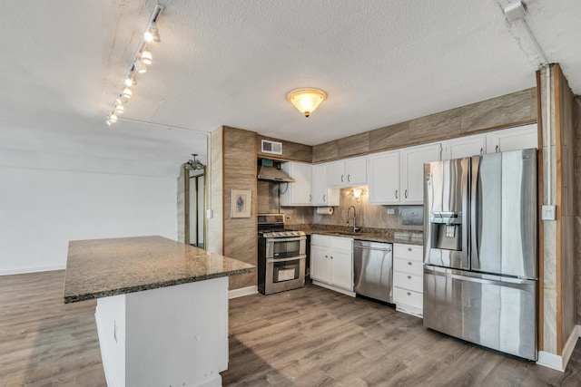 8801 W Golf Rd Unit 10C, Niles, IL 60714 - kitchen with stainless steel appliances, a sink, baseboards, white cabinets, and wood finished floors