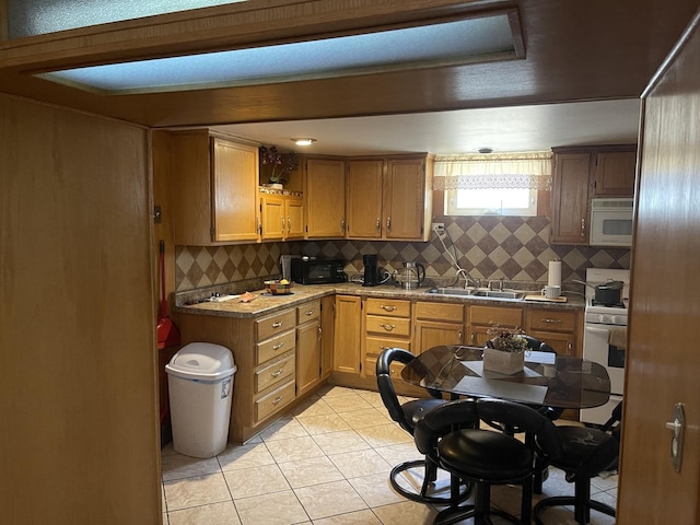 4549 N Canfield Ave, Norridge, IL 60706 - kitchen featuring a sink, white range with gas cooktop, backsplash, light tile patterned floors, and black microwave