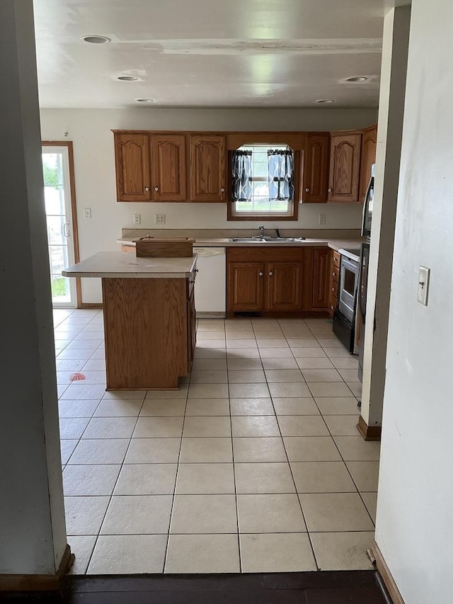 934 Evans St, Ottawa, IL 61350 - kitchen featuring dishwasher, a sink, light tile patterned flooring, a center island, and light countertops