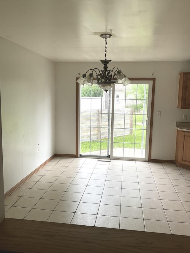 934 Evans St, Ottawa, IL 61350 - unfurnished dining area with a chandelier, light tile patterned floors, and baseboards