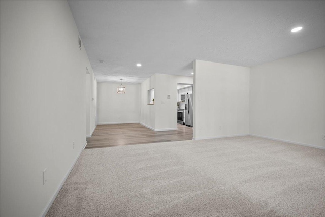 824 Mcgregor St Unit 4, Bloomington, IL 61701 - unfurnished living room featuring light colored carpet and recessed lighting