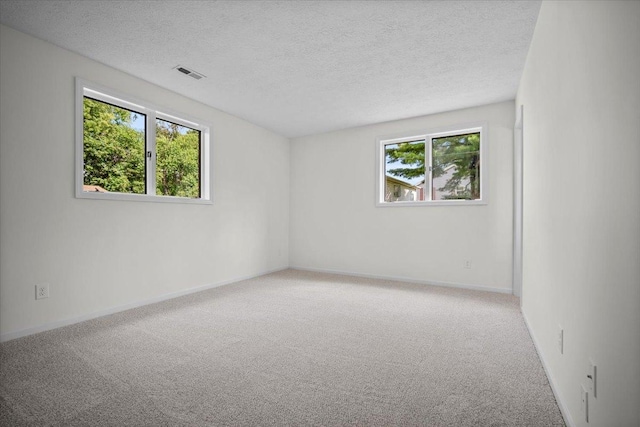 824 Mcgregor St Unit 4, Bloomington, IL 61701 - carpeted spare room with a textured ceiling and baseboards