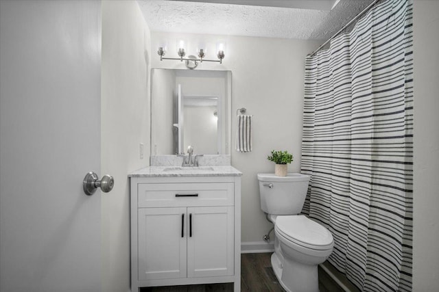 824 Mcgregor St Unit 4, Bloomington, IL 61701 - bathroom featuring a textured ceiling, vanity, wood finished floors, and a shower with curtain