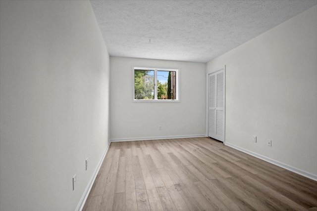 824 Mcgregor St Unit 4, Bloomington, IL 61701 - unfurnished room featuring wood finished floors and a textured ceiling