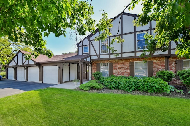 42 Plymouth Ct Unit 202B, Naperville, IL 60565 - tudor-style house featuring driveway, a garage, a front yard, and stucco siding
