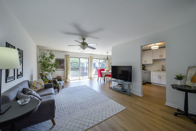42 Plymouth Ct Unit 202B, Naperville, IL 60565 - living area featuring wood finished floors, a ceiling fan, baseboards, and a chandelier