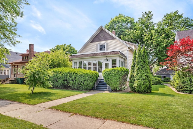 810 Glenwood Ave, Joliet, IL 60435 - view of front of property with stairway, a front yard, and a chimney
