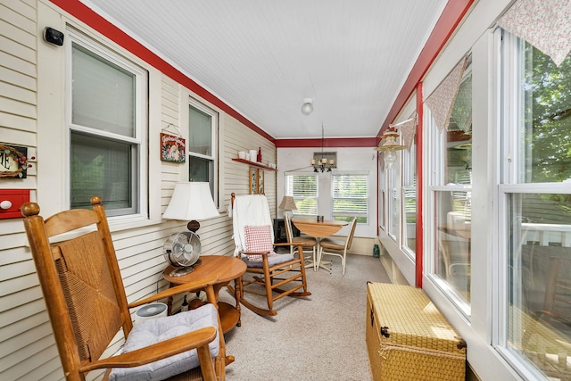 810 Glenwood Ave, Joliet, IL 60435 - sunroom with carpet floors, ornamental molding, a chandelier, and wood walls